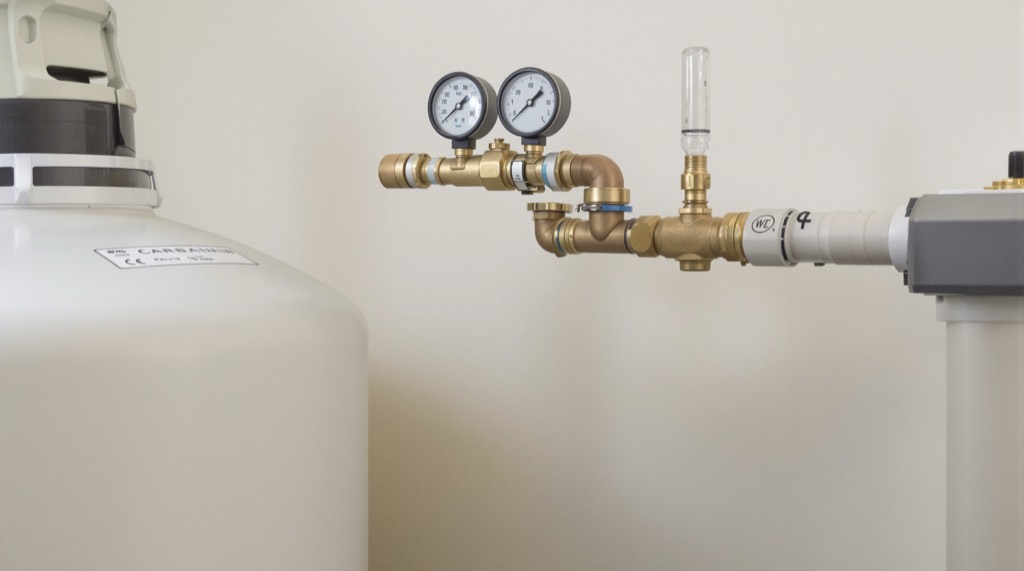 A brass bypass manifold on a whole-house water filtration tie-in